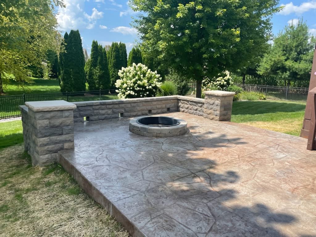 Stamped concrete patio with fire pit by Horrighs Concrete